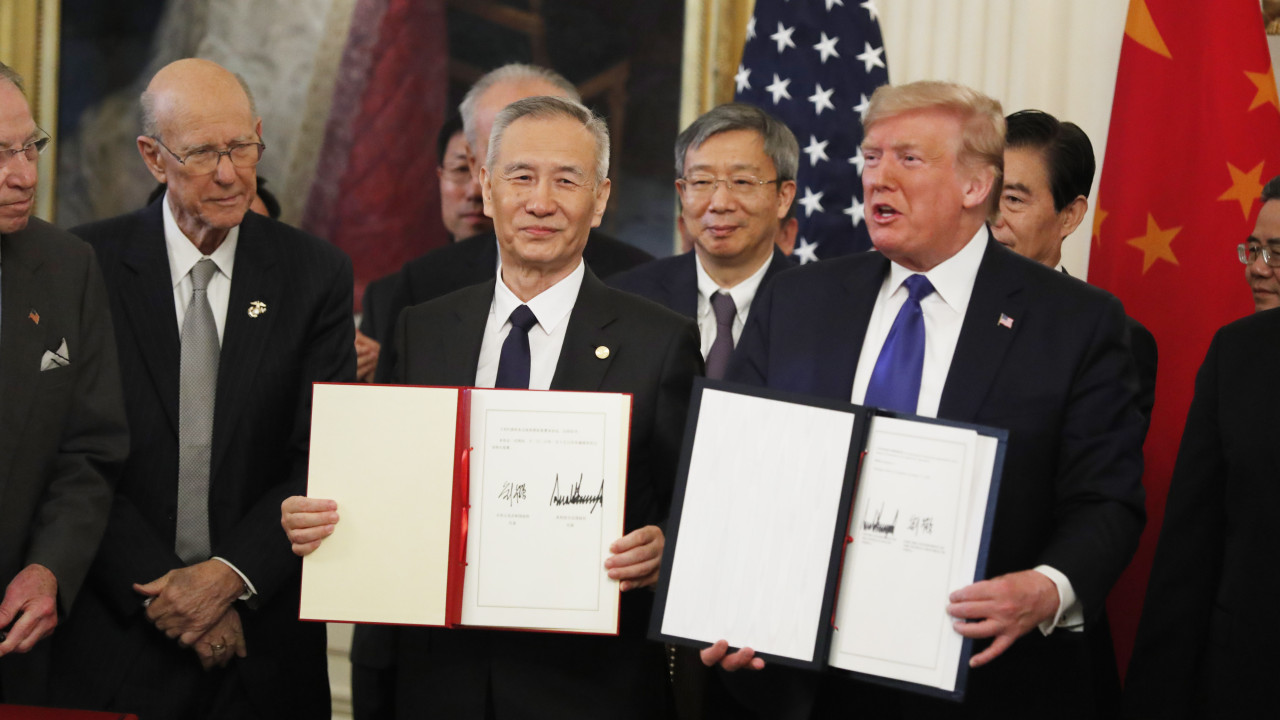 U.S. President Donald Trump and Chinese Vice Premier Liu He show the signed China-U.S. phase-one economic and trade agreement