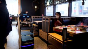 A robot transports food to serve to diners at a restaurant, following an outbreak of the novel coronavirus disease (COVID-19), in Shanghai, China March 19, 2020. REUTERS/Aly Song (China)