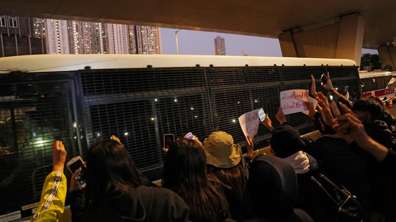 Supporters surround a police van after the sentencing of pro-democracy activists Joshua Wong, Agnes Chow and Ivan Lam, at West Kowloon Magistrates' Courts in Hong Kong, China December 2, 2020. REUTERS/Lam Yik (China)