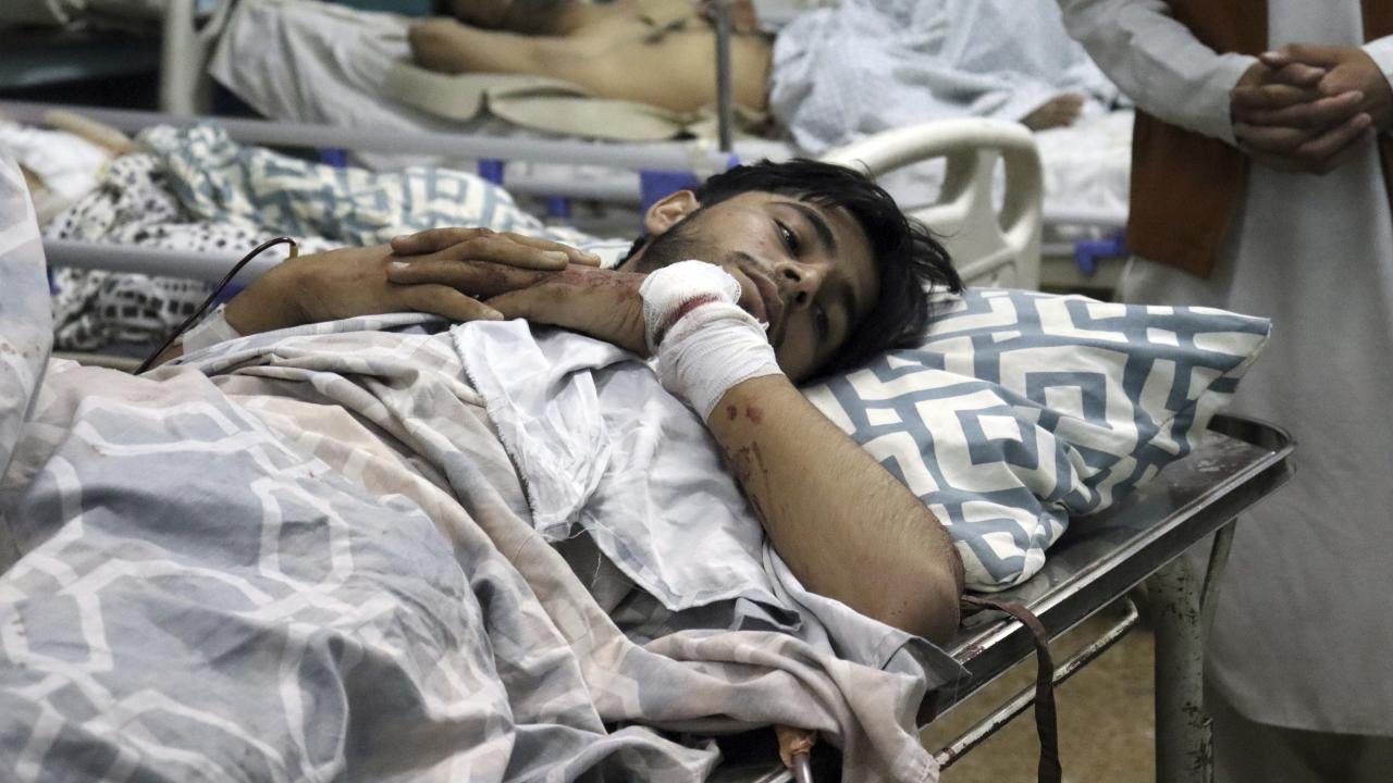 Afghans lie on beds at a hospital after they were wounded in the deadly attacks outside the airport in Kabul, Afghanistan, Thursday, Aug. 26, 2021. Two suicide bombers and gunmen attacked crowds of Afghans flocking to Kabul's airport Thursday, transforming a scene of desperation into one of horror in the waning days of an airlift for those fleeing the Taliban takeover. (AP Photo/Khwaja Tawfiq Sediqi)