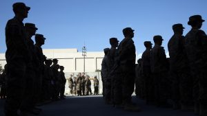 U.S. service members stand during a ceremony on the thirteenth anniversary of the 9/11 terrorist attacks in front of the World Trade Center Memorial, at Bagram Airfield, Afghanistan Thursday, Sept. 11, 2014. (AP Photo/Massoud Hossaini)